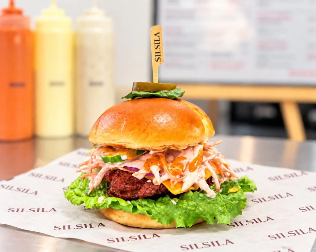 Freshly made Silsila burger with coleslaw and sauce